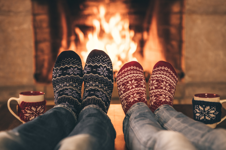 warming feet in socks by fireplace
