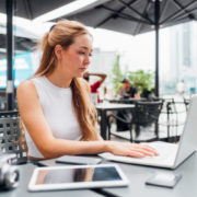 girl sitting outdoors working remotely
