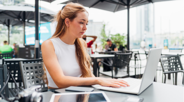 girl sitting outdoors working remotely